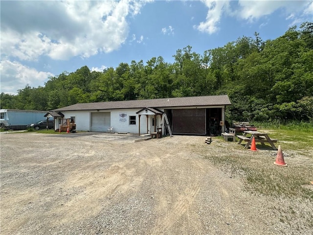 1389 Indian Creek Valley Rd, Saltlick Twp, PA 15462 - garage featuring a view of trees and dirt driveway