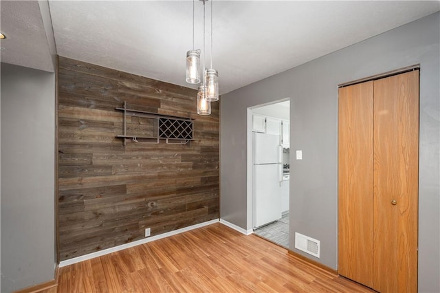 155 Spruce Ct, Ross Twp, PA 15229 - unfurnished dining area with wood finished floors and wood walls