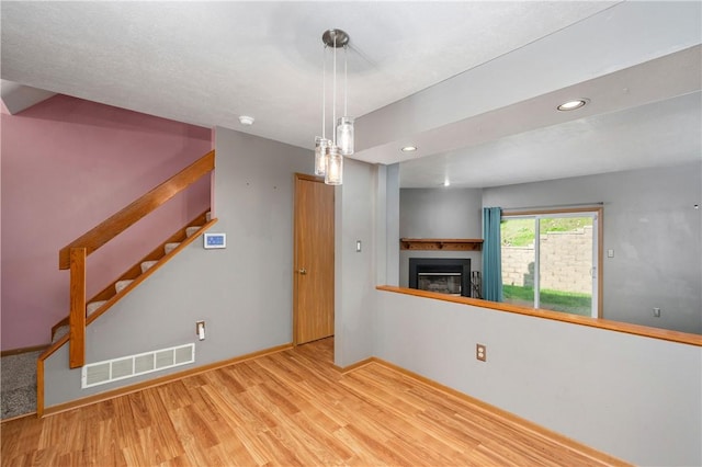 155 Spruce Ct, Ross Twp, PA 15229 - unfurnished living room featuring a fireplace, wood finished floors, stairway, and recessed lighting
