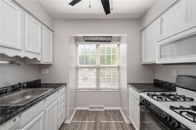 155 Spruce Ct, Ross Twp, PA 15229 - kitchen featuring gas range, dark countertops, and white microwave