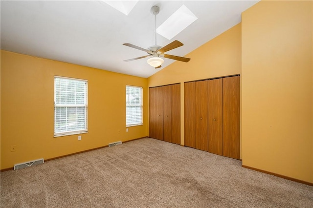 155 Spruce Ct, Ross Twp, PA 15229 - unfurnished bedroom with vaulted ceiling, carpet, two closets, a skylight, and a ceiling fan