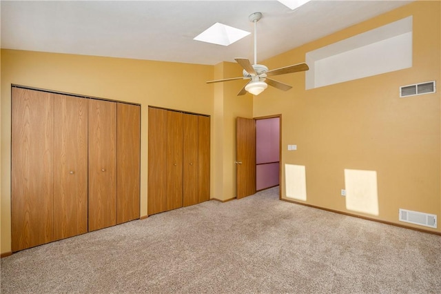 155 Spruce Ct, Ross Twp, PA 15229 - unfurnished bedroom with a skylight, carpet flooring, two closets, a ceiling fan, and high vaulted ceiling