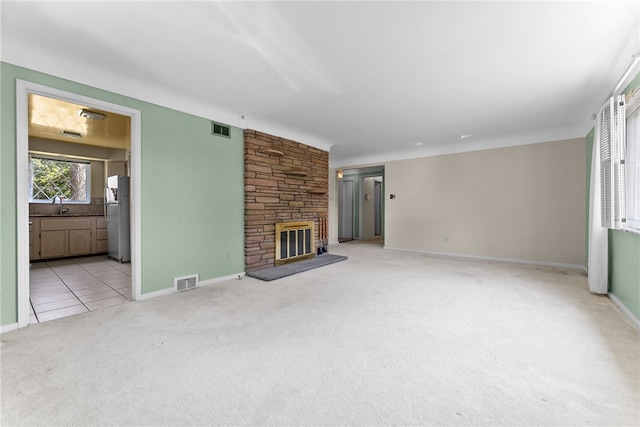 1228 Pinewood Dr, Mt Lebanon, PA 15243 - unfurnished living room with light colored carpet, a stone fireplace, and light tile patterned floors
