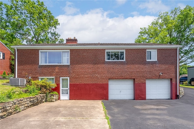 1228 Pinewood Dr, Mt Lebanon, PA 15243 - view of front of home featuring asphalt driveway, a chimney, brick siding, and an attached garage