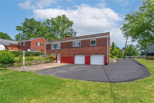 1228 Pinewood Dr, Mt Lebanon, PA 15243 - back of property featuring driveway, a garage, a chimney, brick siding, and a yard