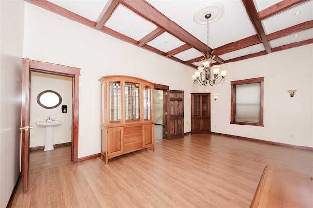 669 Franklin St, Cherryhll Twp/Clymer, PA 15728 - unfurnished dining area featuring coffered ceiling, light wood-style flooring, beam ceiling, and a chandelier
