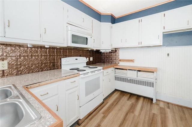 669 Franklin St, Cherryhll Twp/Clymer, PA 15728 - kitchen with white appliances, light countertops, radiator, light wood-style floors, and white cabinets