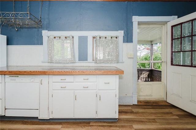 669 Franklin St, Cherryhll Twp/Clymer, PA 15728 - kitchen featuring white dishwasher, white cabinetry, a wainscoted wall, wood finished floors, and light countertops