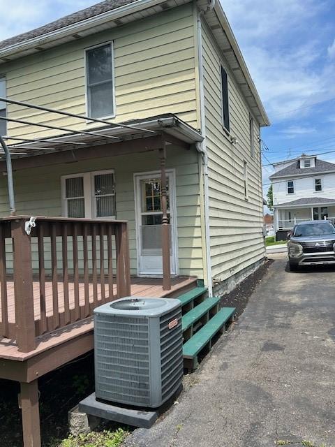 104 Whyle Ave, North Union Twp, PA 15401 - view of home's exterior featuring a central AC unit and a wooden deck