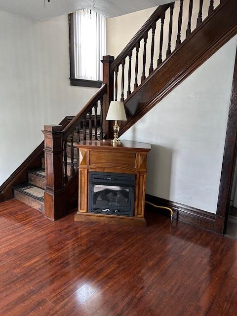 104 Whyle Ave, North Union Twp, PA 15401 - stairs featuring wood finished floors and a glass covered fireplace