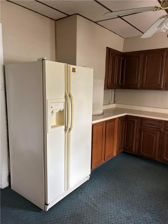 104 Whyle Ave, North Union Twp, PA 15401 - kitchen featuring white fridge with ice dispenser, dark colored carpet, light countertops, and a ceiling fan
