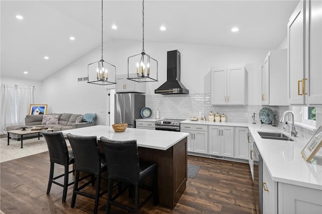 521 Creek Rd, Smith, PA 15019 - kitchen featuring wall chimney range hood, appliances with stainless steel finishes, light countertops, a kitchen island, and high vaulted ceiling