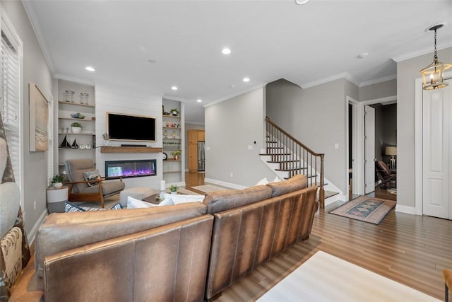 403 Cayuga Cir, Marshall, PA 16046 - living room featuring ornamental molding, a glass covered fireplace, stairs, wood finished floors, and recessed lighting