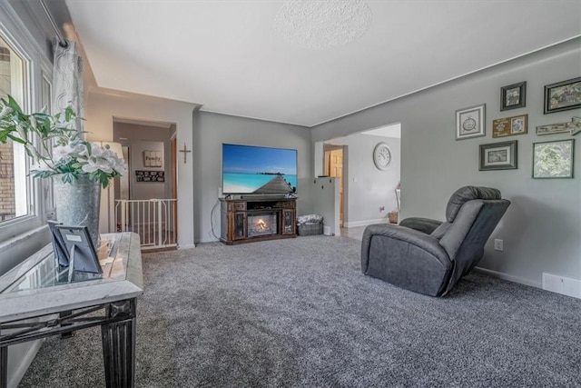 360 Jo Ann Dr, Monessen, PA 15062 - carpeted living room featuring baseboards and a warm lit fireplace