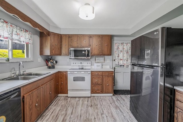 360 Jo Ann Dr, Monessen, PA 15062 - kitchen featuring appliances with stainless steel finishes, light wood finished floors, brown cabinets, and light countertops
