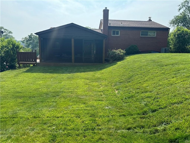 5301 Ranchview Dr, Baldwin Boro, PA 15236 - back of house with a sunroom, a yard, a chimney, and brick siding