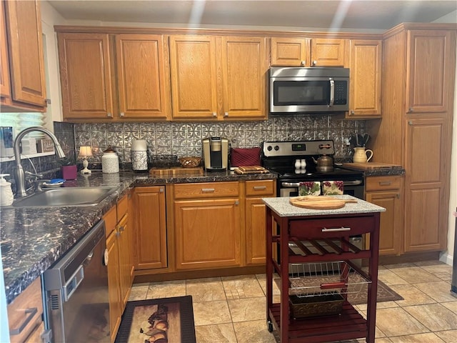 5301 Ranchview Dr, Baldwin Boro, PA 15236 - kitchen with appliances with stainless steel finishes, decorative backsplash, brown cabinetry, and dark stone counters