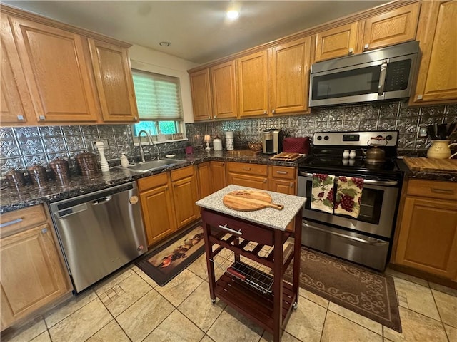 5301 Ranchview Dr, Baldwin Boro, PA 15236 - kitchen with stainless steel appliances, decorative backsplash, brown cabinetry, and dark stone countertops