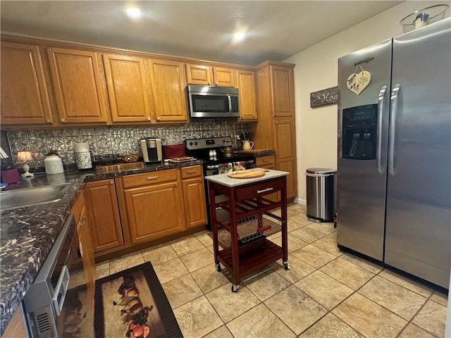 5301 Ranchview Dr, Baldwin Boro, PA 15236 - kitchen featuring stainless steel appliances, backsplash, brown cabinetry, and dark countertops