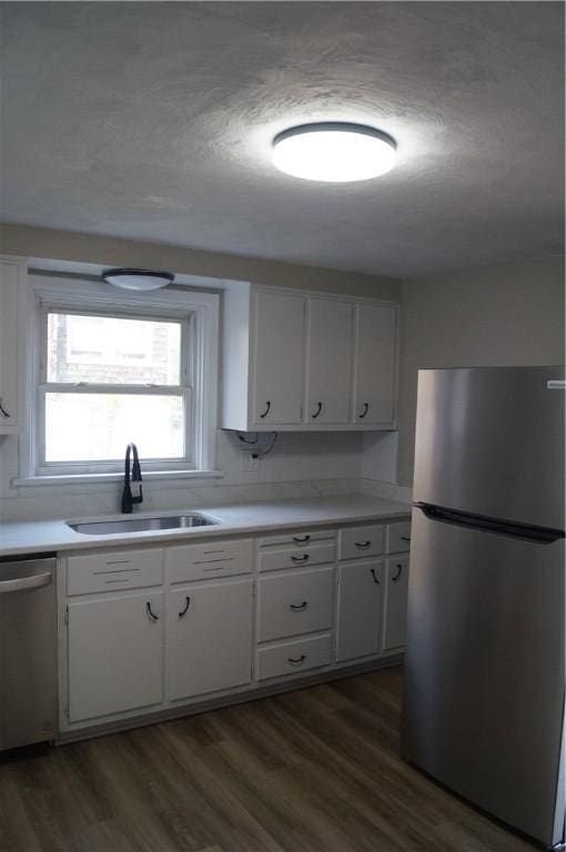 9 E Gaskill Ave, Jeannette, PA 15644 - kitchen featuring stainless steel appliances, dark wood-type flooring, white cabinetry, light countertops, and a textured ceiling