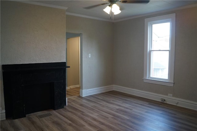 9 E Gaskill Ave, Jeannette, PA 15644 - unfurnished room with wood finished floors, ornamental molding, a ceiling fan, and a fireplace
