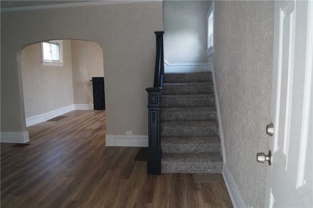 9 E Gaskill Ave, Jeannette, PA 15644 - stairway featuring arched walkways, wood finished floors, crown molding, and a textured wall