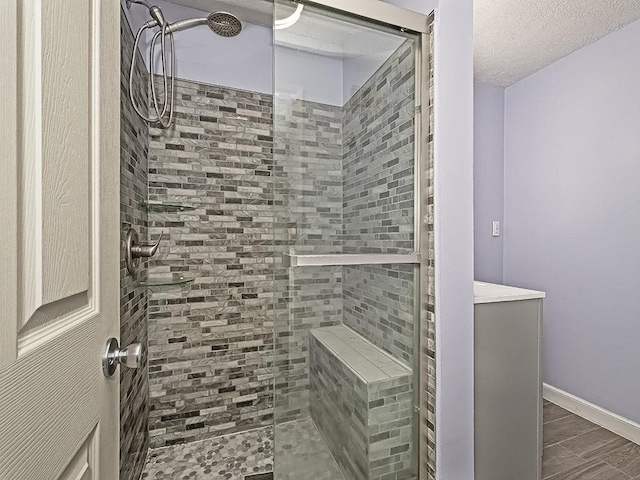 165 Monks Rd, Clinton Twp, PA 16056 - bathroom with tiled shower, a textured ceiling, and wood finished floors