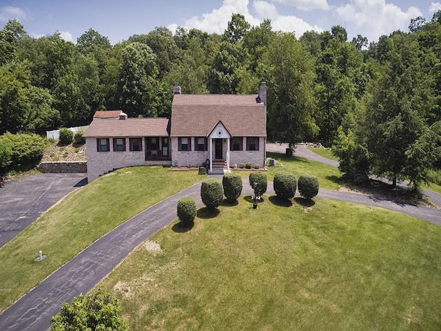 165 Monks Rd, Clinton Twp, PA 16056 - dutch colonial featuring driveway, a front lawn, a chimney, a forest view, and brick siding
