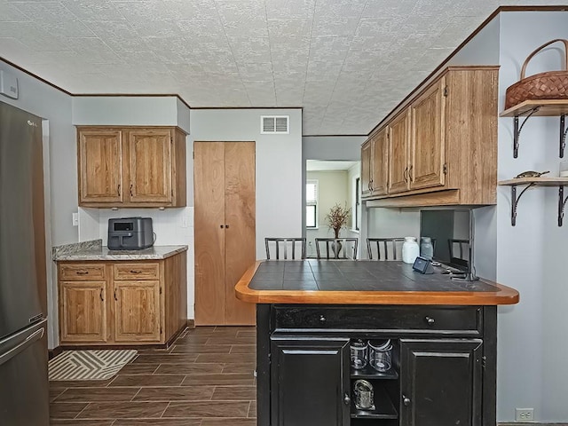 165 Monks Rd, Clinton Twp, PA 16056 - kitchen featuring freestanding refrigerator, open shelves, dark wood-style flooring, and brown cabinetry