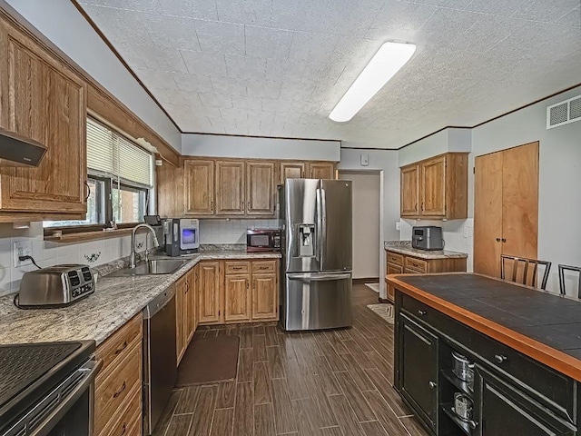 165 Monks Rd, Clinton Twp, PA 16056 - kitchen with stainless steel appliances, brown cabinets, and dark wood-style flooring