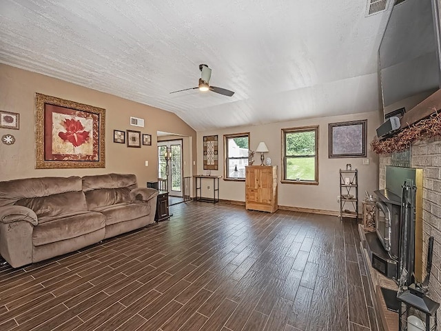 165 Monks Rd, Clinton Twp, PA 16056 - living room featuring vaulted ceiling, a ceiling fan, a fireplace, and dark wood-style flooring