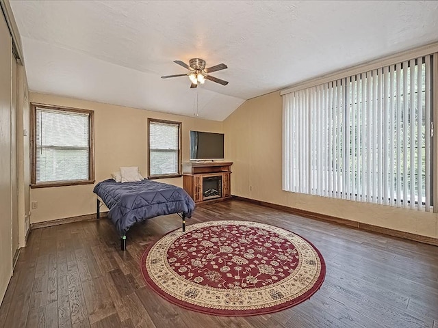 165 Monks Rd, Clinton Twp, PA 16056 - bedroom featuring vaulted ceiling, wood finished floors, multiple windows, ceiling fan, and a fireplace
