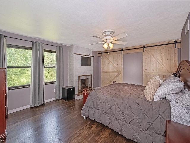 165 Monks Rd, Clinton Twp, PA 16056 - bedroom with a barn door, wood finished floors, wooden walls, and ceiling fan