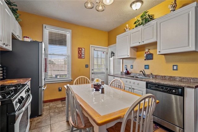 322 Darsie St, Bloomfield, PA 15224 - kitchen featuring stainless steel appliances, white cabinetry, and light tile patterned floors