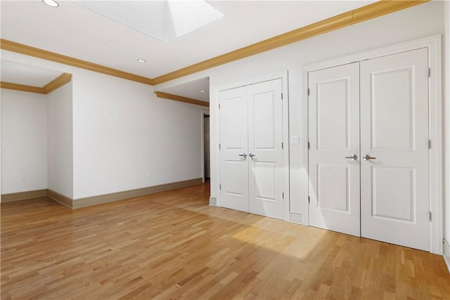 537 N Neville St Unit 6A, Shadyside, PA 15213 - unfurnished bedroom with crown molding, a skylight, two closets, light wood-style flooring, and recessed lighting