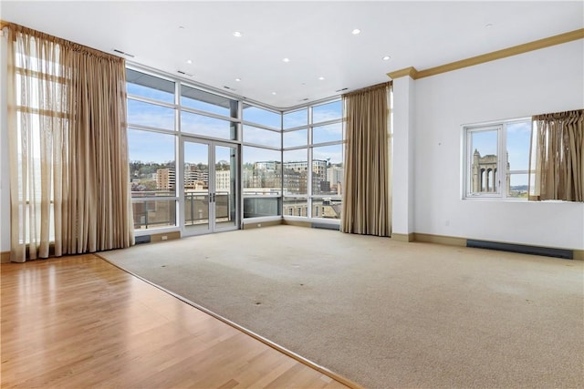 537 N Neville St Unit 6A, Shadyside, PA 15213 - empty room with a view of city, crown molding, expansive windows, carpet floors, and wood finished floors