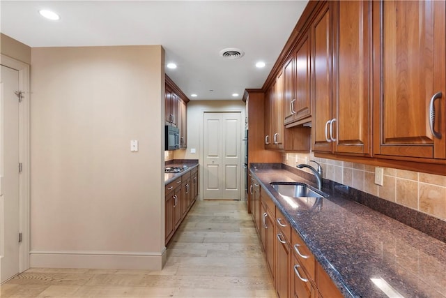 537 N Neville St Unit 6A, Shadyside, PA 15213 - kitchen featuring dark stone countertops, brown cabinets, light wood-style flooring, decorative backsplash, and recessed lighting