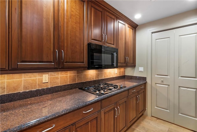 537 N Neville St Unit 6A, Shadyside, PA 15213 - kitchen featuring black appliances, tasteful backsplash, light wood-type flooring, recessed lighting, and dark stone countertops