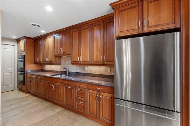 537 N Neville St Unit 6A, Shadyside, PA 15213 - kitchen with freestanding refrigerator, brown cabinets, light wood finished floors, decorative backsplash, and recessed lighting