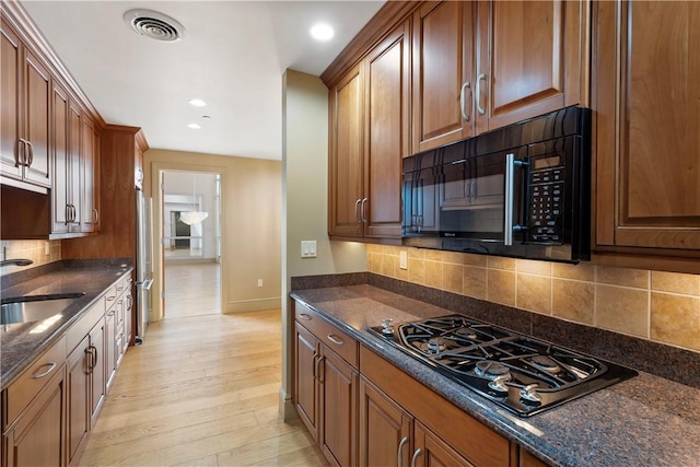 537 N Neville St Unit 6A, Shadyside, PA 15213 - kitchen with black appliances, dark stone counters, decorative backsplash, recessed lighting, and light wood-type flooring