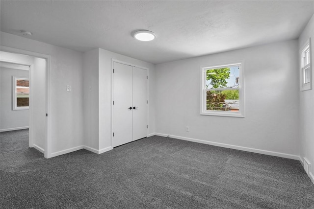 4736 Doyle Rd, Whitehall, PA 15227 - unfurnished bedroom with dark carpet and a closet