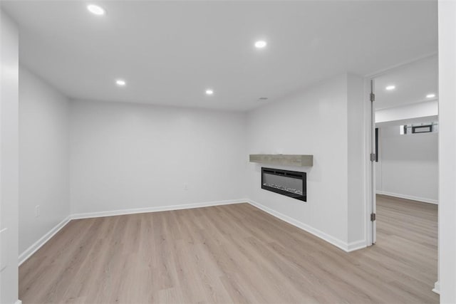4736 Doyle Rd, Whitehall, PA 15227 - unfurnished living room with wood finished floors, recessed lighting, and a glass covered fireplace