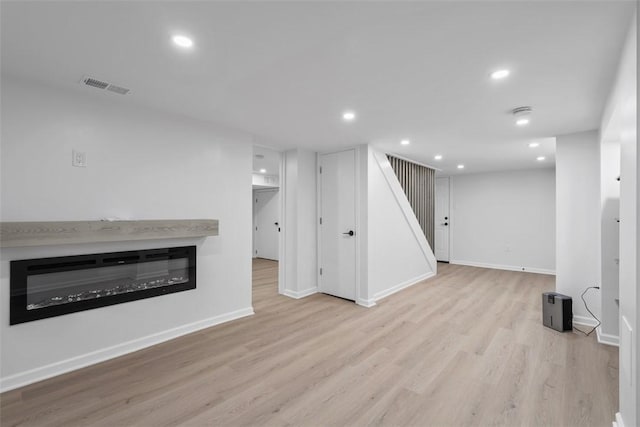 4736 Doyle Rd, Whitehall, PA 15227 - finished basement featuring wood finished floors, a glass covered fireplace, stairs, and recessed lighting