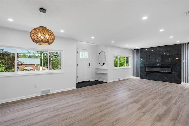 4736 Doyle Rd, Whitehall, PA 15227 - unfurnished living room featuring wood finished floors, recessed lighting, and a fireplace
