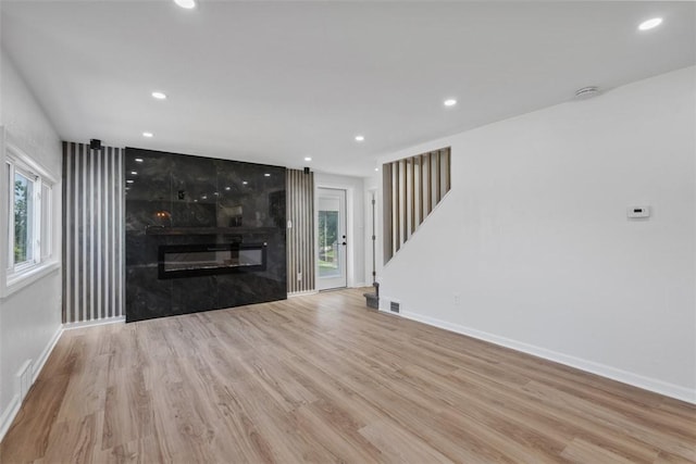 4736 Doyle Rd, Whitehall, PA 15227 - unfurnished living room with stairway, wood finished floors, recessed lighting, and a large fireplace