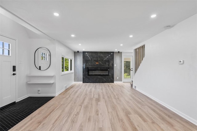 4736 Doyle Rd, Whitehall, PA 15227 - unfurnished living room featuring wood finished floors, recessed lighting, a premium fireplace, and stairway