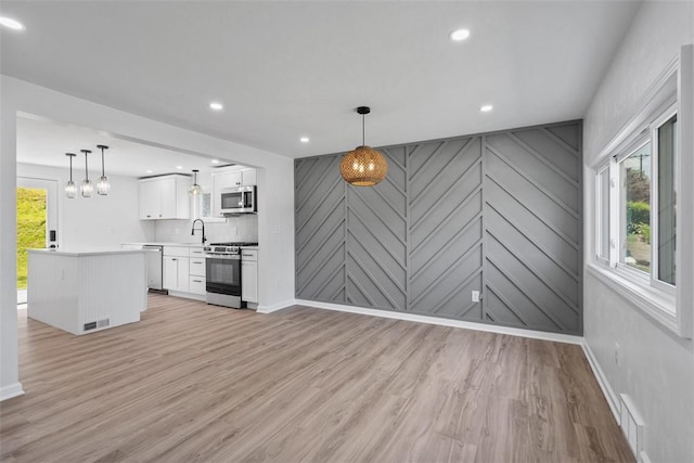 4736 Doyle Rd, Whitehall, PA 15227 - unfurnished living room featuring plenty of natural light, light wood finished floors, and recessed lighting
