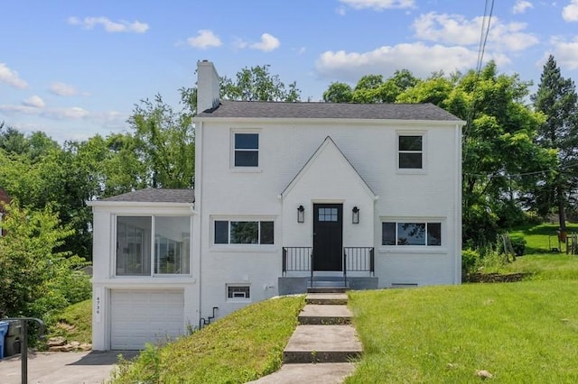 4736 Doyle Rd, Whitehall, PA 15227 - view of front of property featuring a garage, a chimney, a front lawn, and driveway