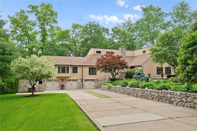 337 Fox Chapel Rd, Fox Chapel, PA 15238 - view of front of house with stucco siding, stone siding, a garage, and concrete driveway