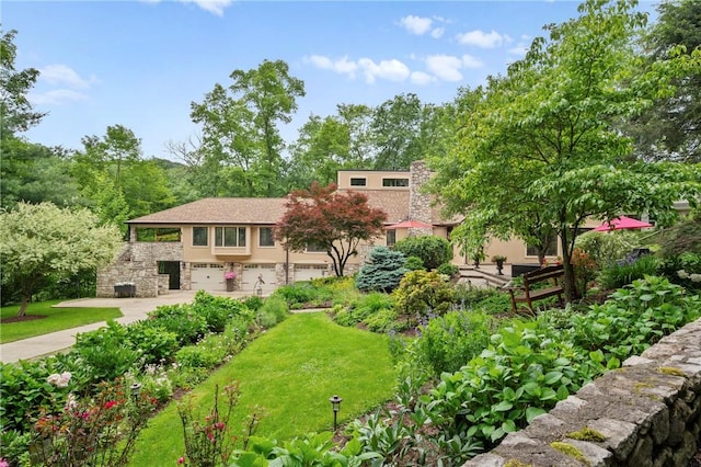 337 Fox Chapel Rd, Fox Chapel, PA 15238 - view of front facade featuring stone siding, stucco siding, concrete driveway, a garage, and a front yard
